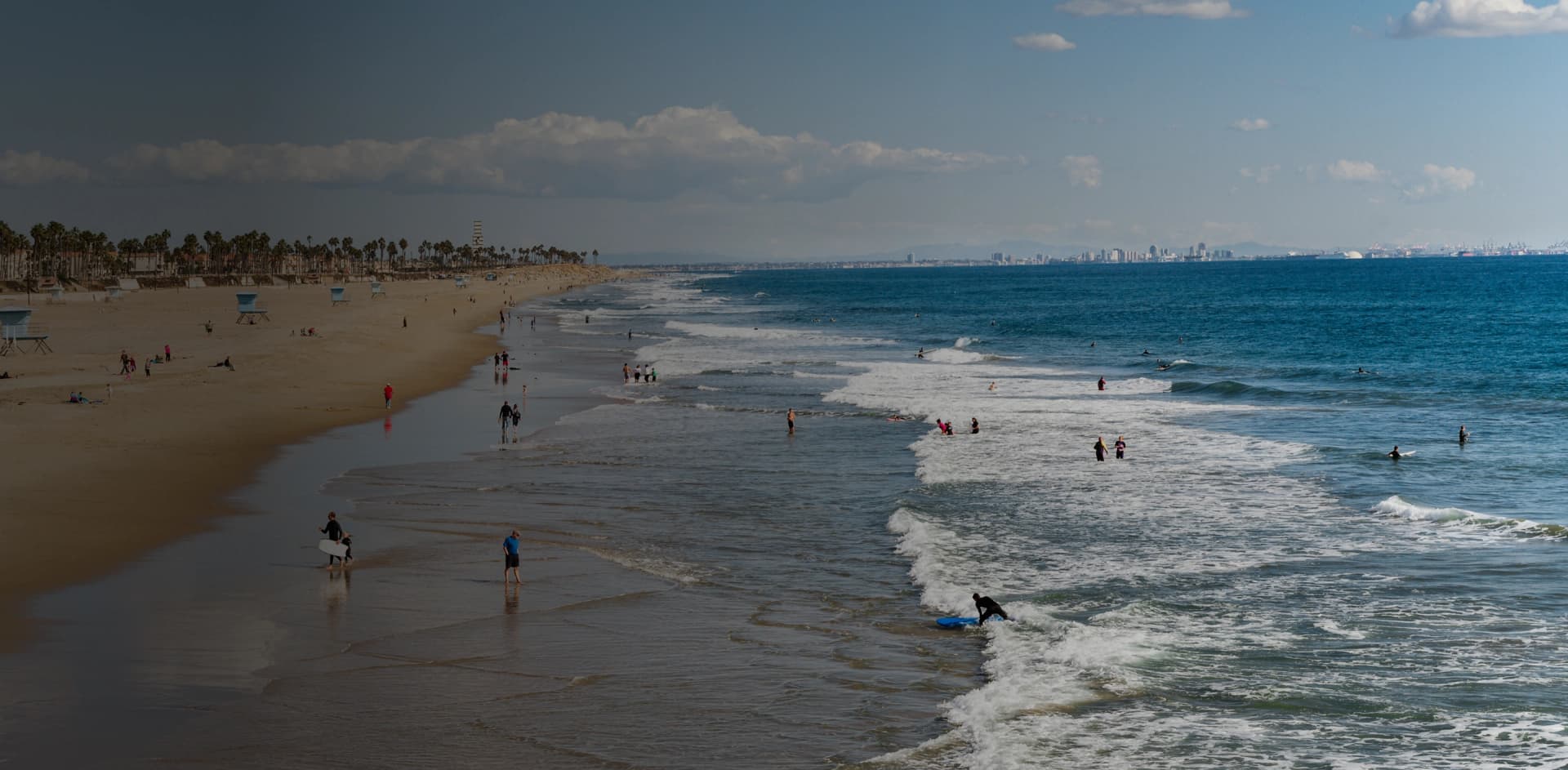 Drug rehab in Seal Beach - Surfers and beachgoers enjoying the waves in Seal Beach — a calm and inviting setting for addiction recovery and healing.