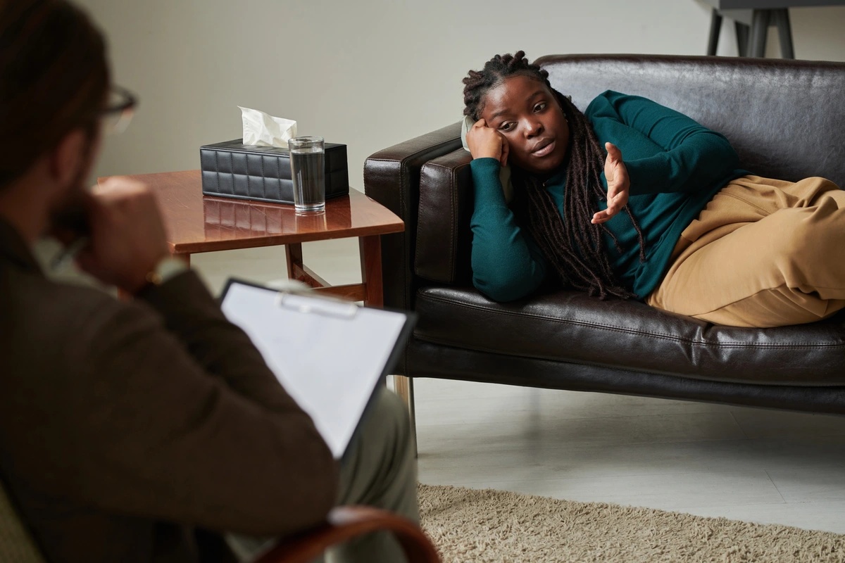 Individual Therapy: Woman reclined in couch talking to a therapist
