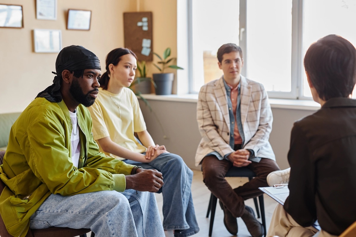 Group Therapy: Group therapist speaking to people