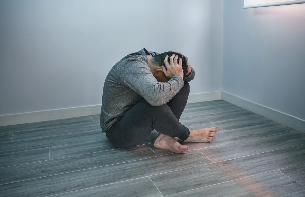 Man Balled up on Floor - Persistent Depressive Disorder