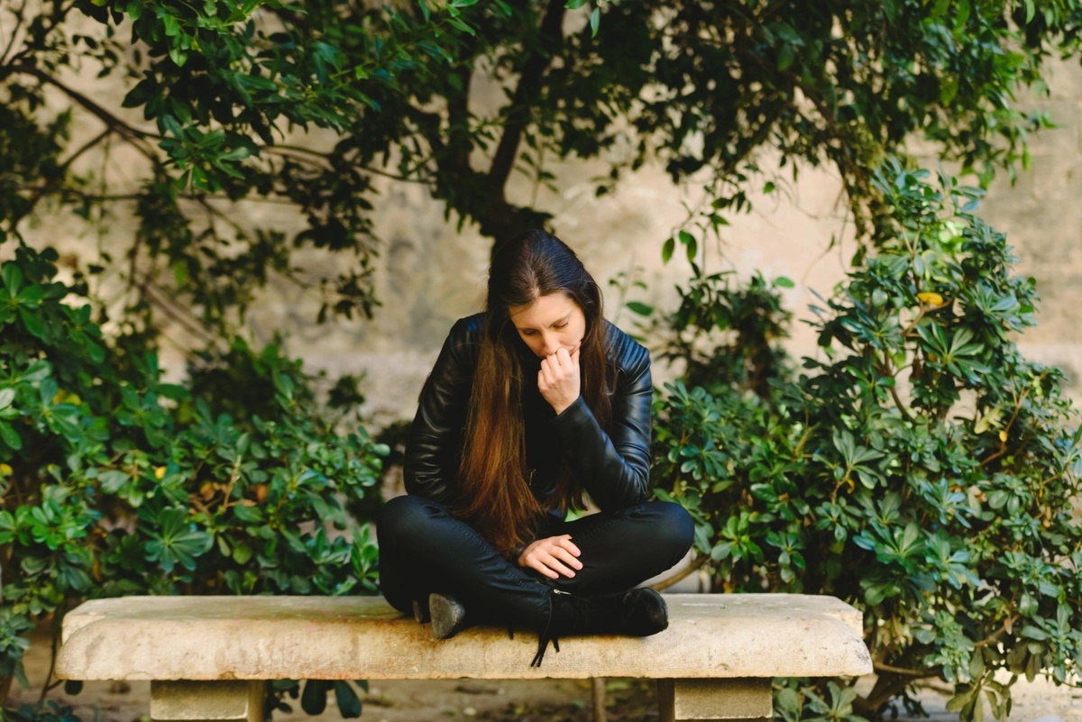Schizoaffective Disorder Woman Sitting on a Bench Outdoors