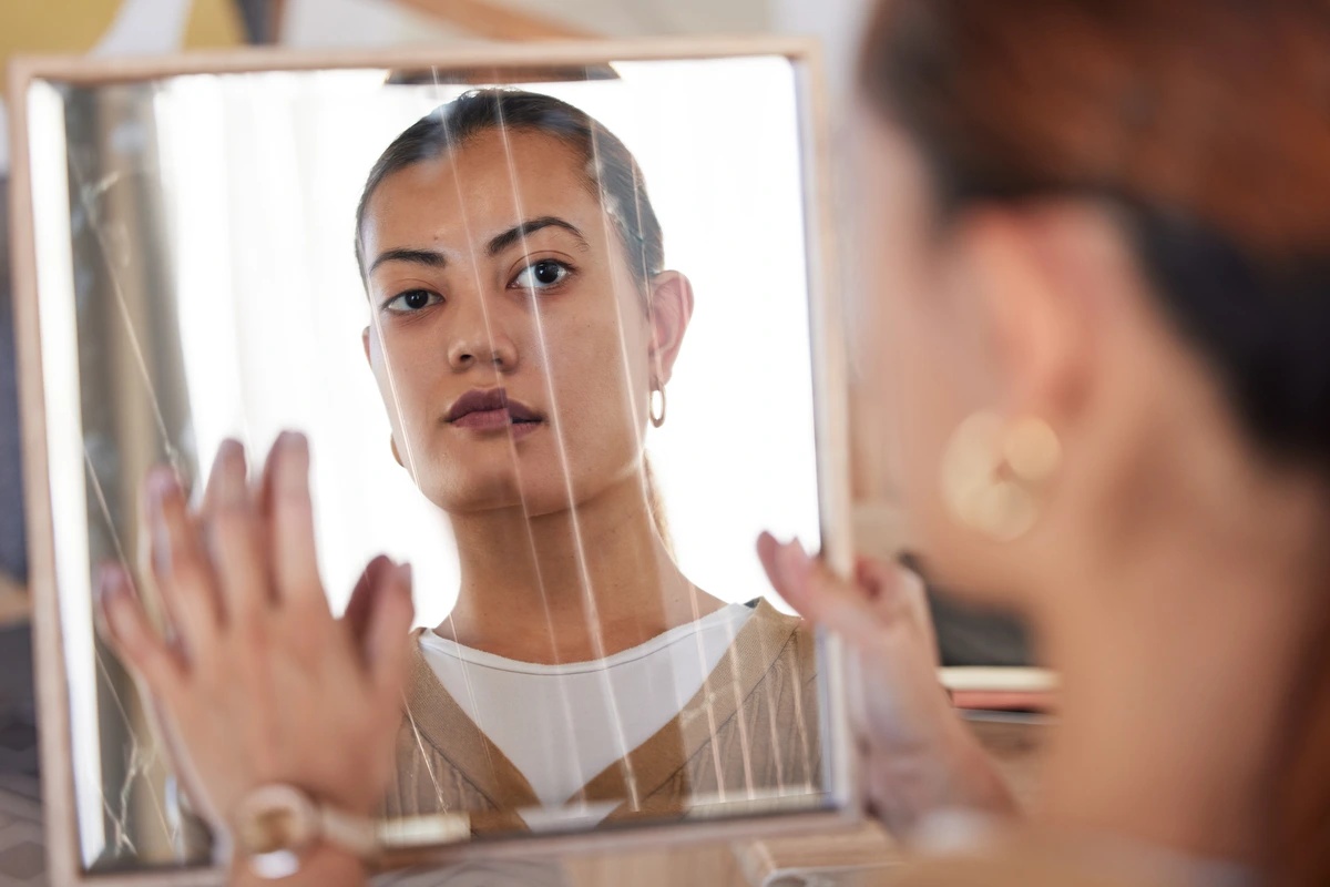 Bipolar Disorder - Woman Looking in Broken Mirror