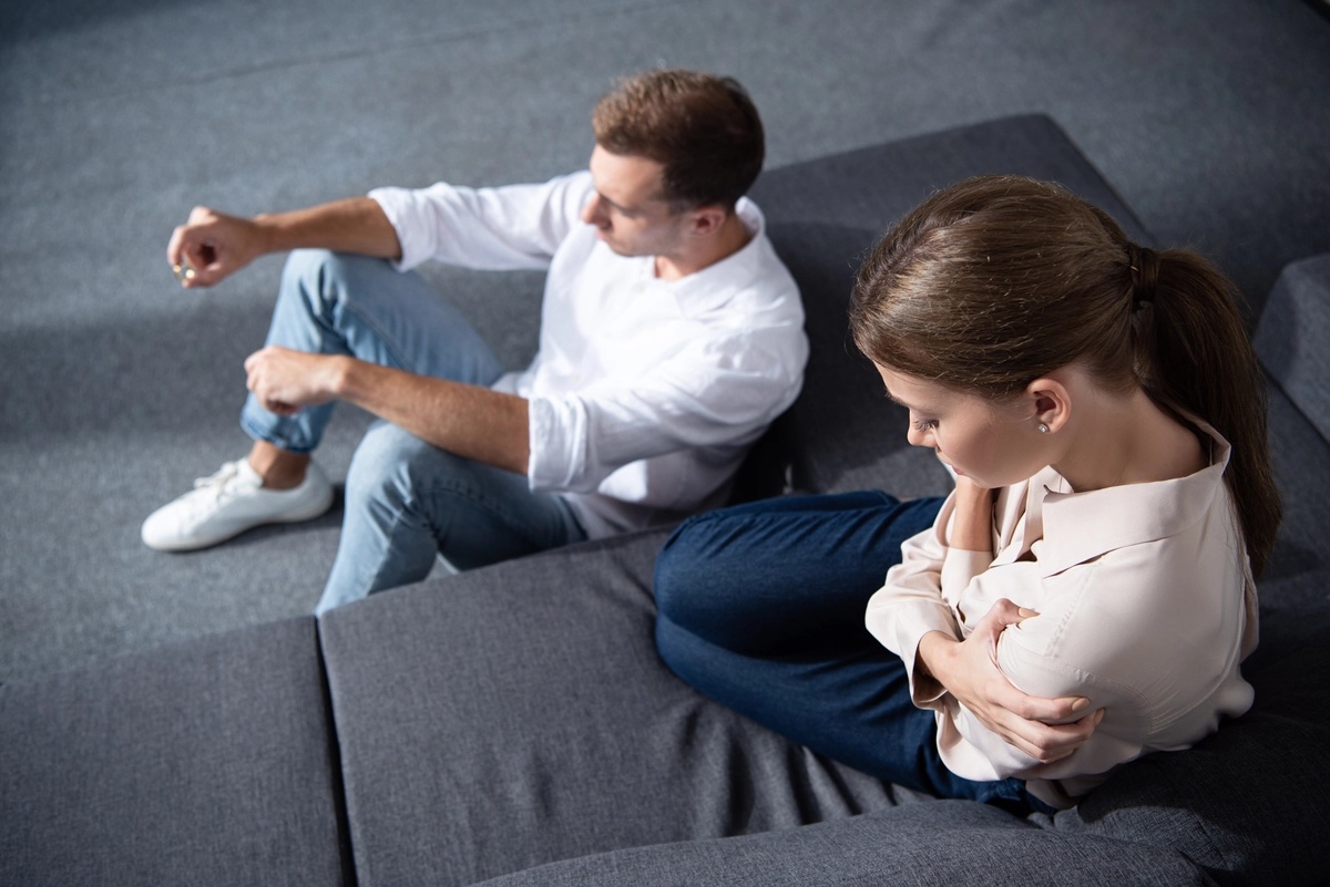 Couple struggling with their issues sitting on the floor