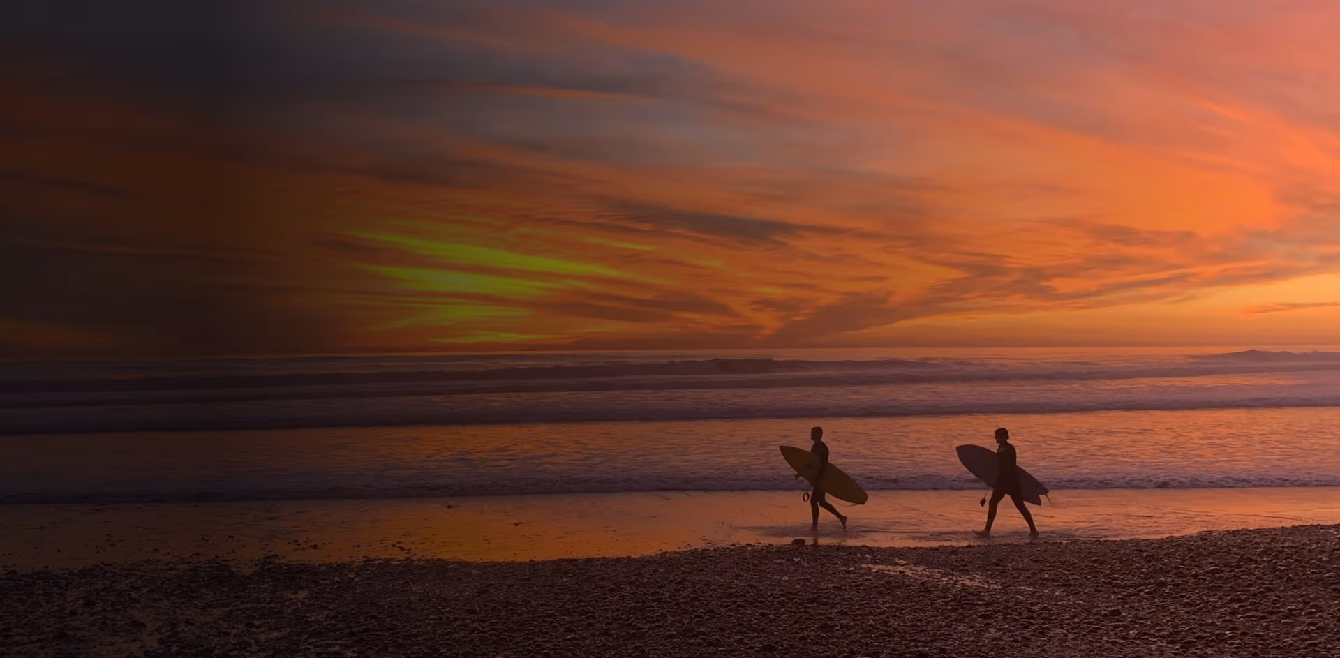 Drug Rehab in Huntington Beach Drug rehab in Huntington Beach - Silhouetted surfers walking at sunset on Huntington Beach — reflecting peace, renewal, and the journey toward recovery.
