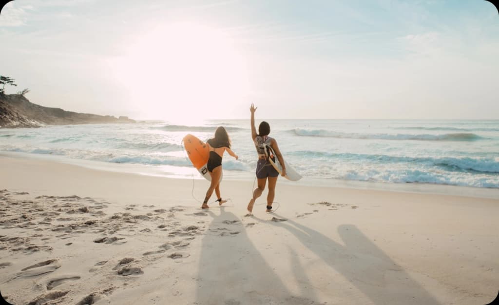 Women celebrating on the shores of Huntington Beach — symbolizing freedom and a fresh start through addiction recovery.