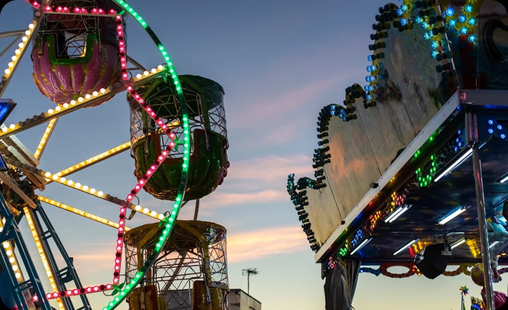Carnival rides glowing at twilight — capturing Garden Grove's vibrant culture and the role of sober living in enjoying local events.