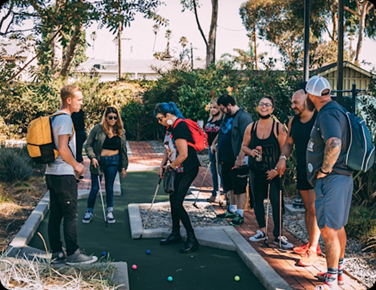 Sober living community enjoying mini golf — San Clemente rehab centers promote fun, healthy activities for recovery.